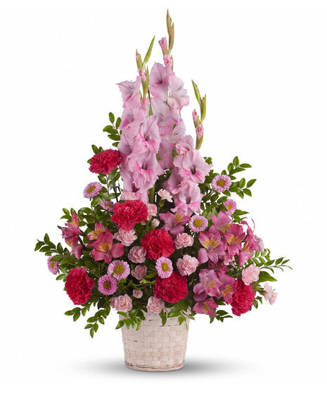 White basket filled with pink sympathy flowers of different varieties
