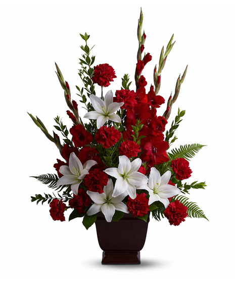 Red and white sympathy flowers presented in an urn